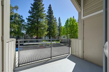 the view of a tennis court from a balcony with a fence